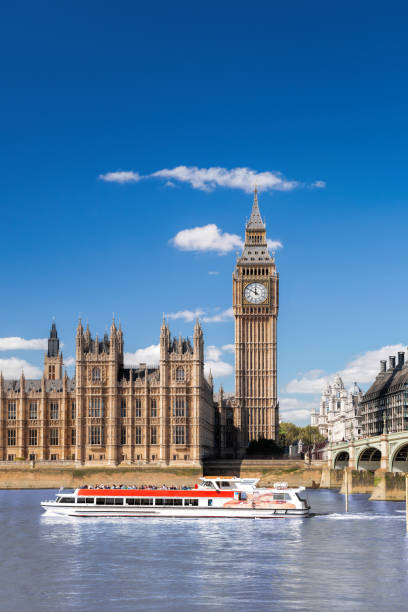 Famous Big Ben with bridge over Thames and tourboat on the river in London, England, UK Famous Big Ben with bridge over Thames and tourboat on the river in London, England, UK passenger craft stock pictures, royalty-free photos & images