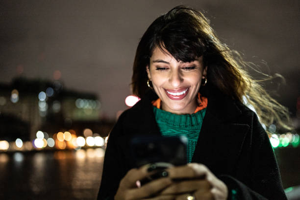 istock Young woman using the mobile phone outdoors 1401524245