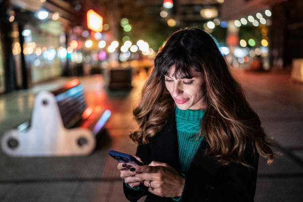 istock Young woman using the mobile phone in the street 1401524455