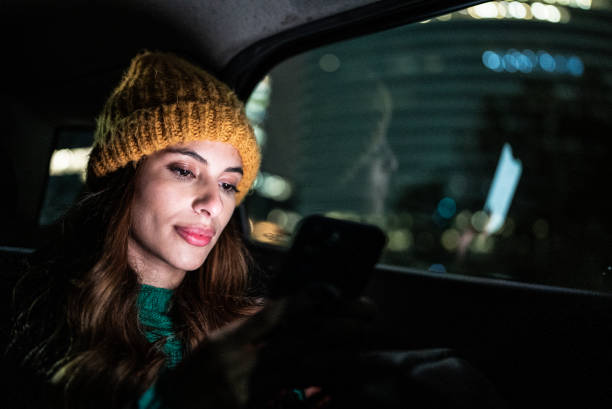 istock Young woman using the mobile phone in the car 1401524479