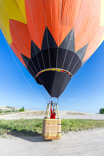 A hot air balloon takes off into the air, Goreme, Cappadocia, Turkey