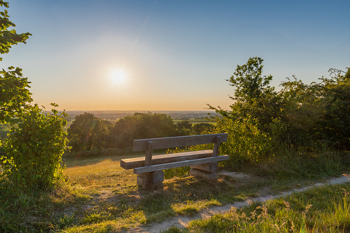 A beautiful sunset late Spring over the rolling hills from south Limburg in Bemelen. The wooden bench is an idyllic place for couples to enjoy a romantic evening overlooking to landscape.