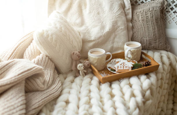 istock Christmas and New Year composition with a soft plaid, pillows, cookies, gingerbread and coffee. Cozy home and winter concept. 1401526178