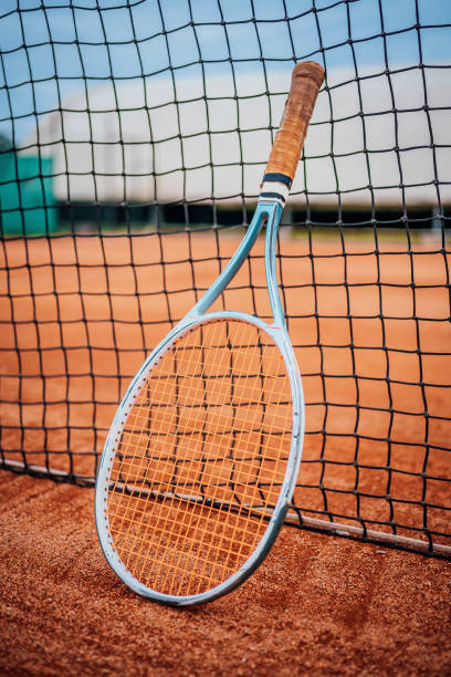istock Tennis racket leaned against the net 1401527422