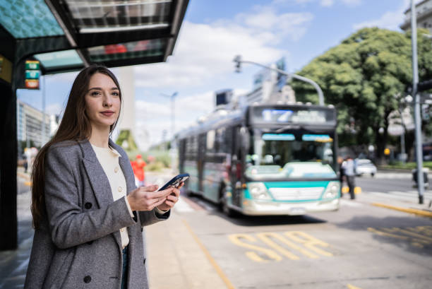 istock Young woman waiting at the bus stop 1401528102