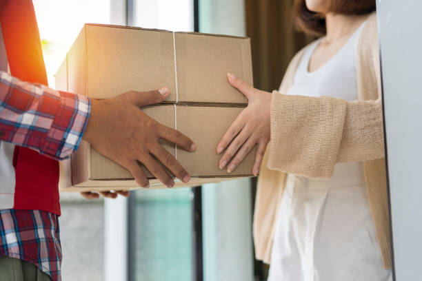 istock Man accepting a delivery of boxes from delivery service courier, parcel delivery 1401530869