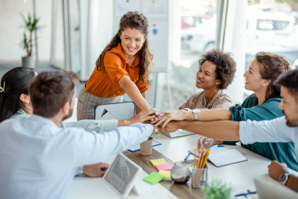 istock Diverse Workers Putting Hands Together in the Office 1401531336