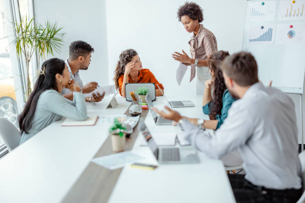 Disagreements in the office Upset Businesswoman Sitting With Aggressive Colleague In Meeting crisis stock pictures, royalty-free photos & images