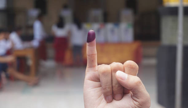 purple ink on finger after presidential election in indonesia. - politician voting politics election imagens e fotografias de stock