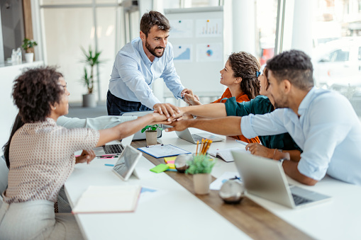 Diverse Workers Putting Hands Together Celebrating Victory in Office. Success and Winning Concept