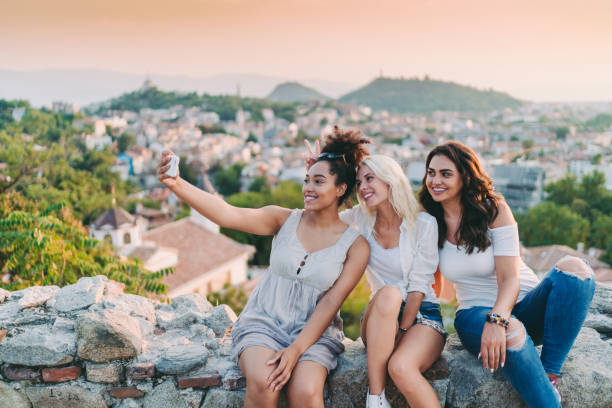 istock Women taking selfies against the cityscape 1401532992
