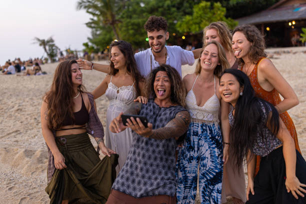 istock Multiracial friends taking selfie with mobile phone on the beach 1401534588