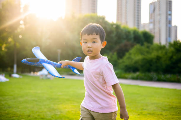 istock kids playing with toy planes in park 1401536002