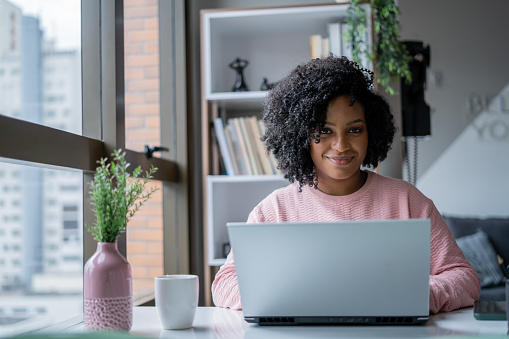 istock Portrait of black woman working from home 1401536669