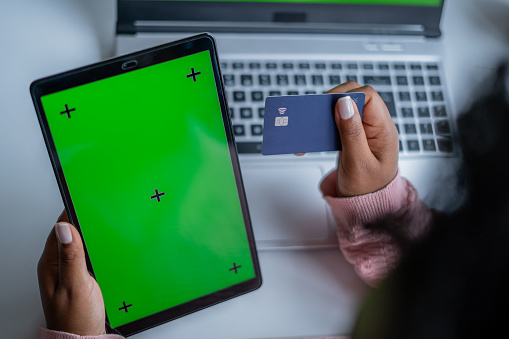Black woman shopping online using digital tablet - Green screen