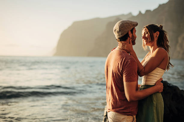 istock Young couple hugging on the beach at sunset 1401539696