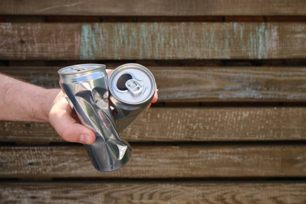istock Crumpled tin can in hand. Recyclable material. Environmental protection. Zero waste. Used beverage containers 1401540722