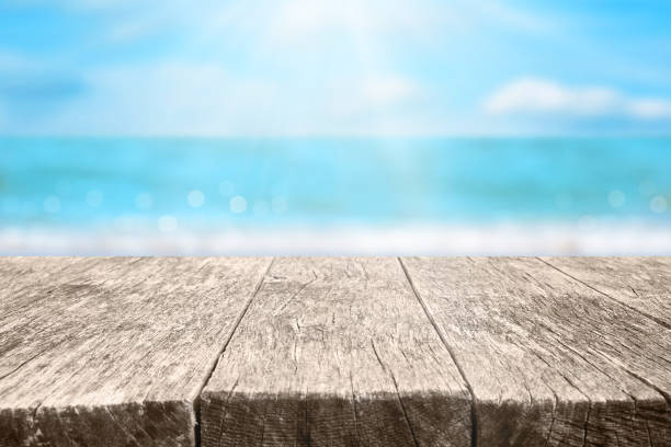 istock Wood table over sea and beach background in summer day. 1401542222
