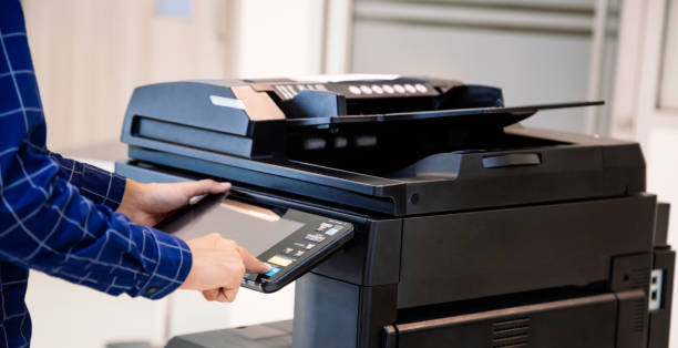 istock Businessmen press button on the panel for using photocopier or printer for printout and scanning document paper at office. 1401543743