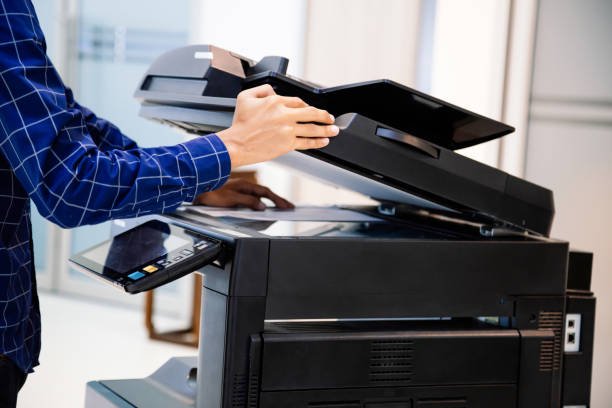 istock Businessmen press button on the panel for using photocopier or printer for printout and scanning document paper at office. 1401543745