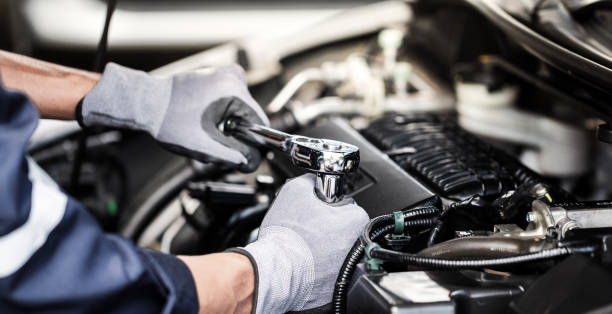 Professional mechanic working on the engine of the car in the garage. Car repair service. Professional mechanic working on the engine of the car in the garage. Car repair service. car mechanic stock pictures, royalty-free photos & images