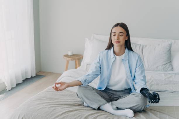 istock Meditation and concentration. Morning routine of disabled woman with artificial cyber limb. 1401548657