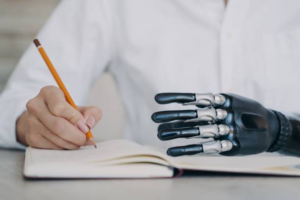 istock Cyber arm and healthy limb on the notebook. Woman with bionic prosthesis is studying remotely. 1401548671