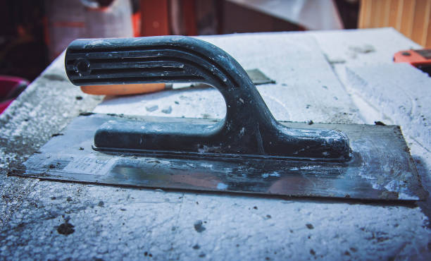 istock Metal building spatulas, closeup of mason tools 1401553637