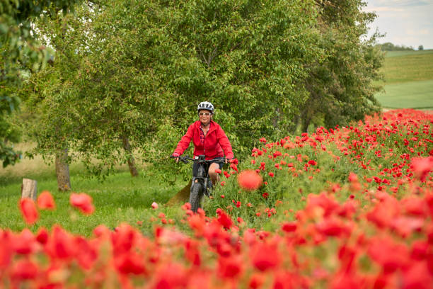 istock woman on electric bicycle  between blooming poppies 1401553941