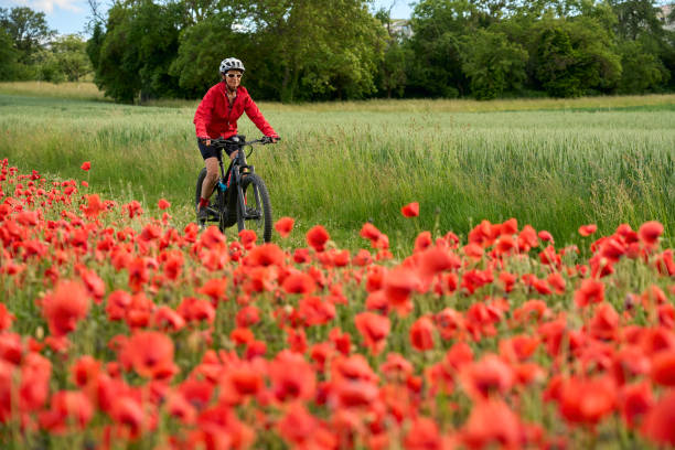 istock woman on electric bicycle  between blooming poppies 1401553961