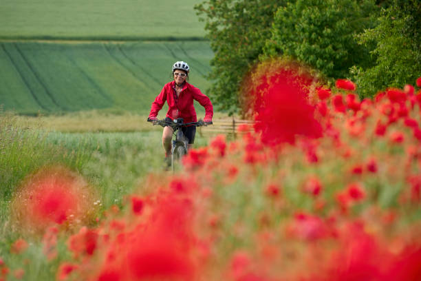 istock woman on electric bicycle  between blooming poppies 1401553994