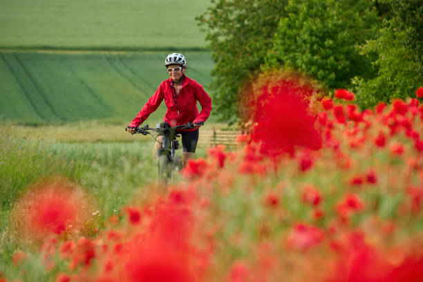 istock woman on electric bicycle  between blooming poppies 1401554655
