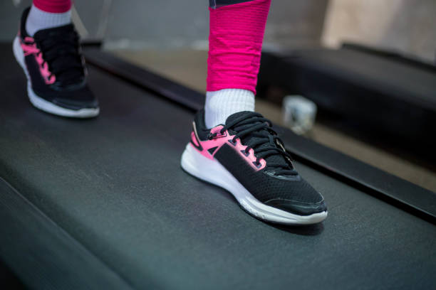 Jogging on treadmill, focus on the treadmill, blurred motion