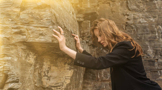 istock Business lady pushing a boulder, Hard work like pushing a mountain, burden or obstacle, business difficulties, struggle, challenge to success, motivation or perseverance concept 1401556447