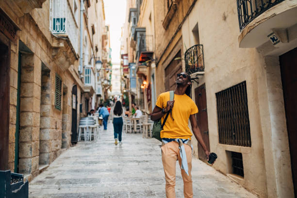 istock A smiling black Latin American enjoys sightseeing the old town 1401556952