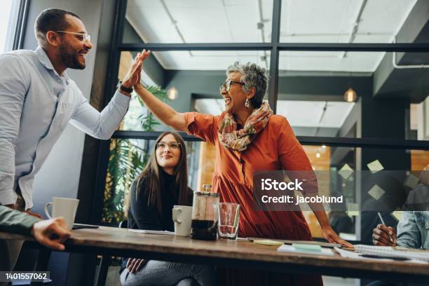 Cheerful Business Colleagues Celebrating Their Success Stock Photo - Download Image Now
