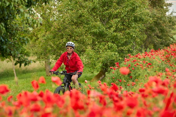 istock woman on electric bicycle  between blooming poppies 1401557149