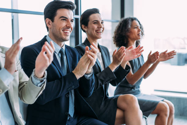 istock Businesspeople applauding during a seminar in conference hall. 1401557242