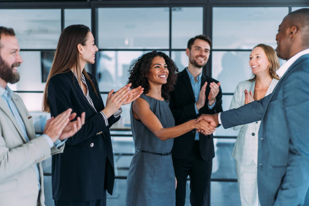 Successful partnership Business people shaking hands in the office. Business persons handshaking during a meeting in modern office. employee introduction stock pictures, royalty-free photos & images