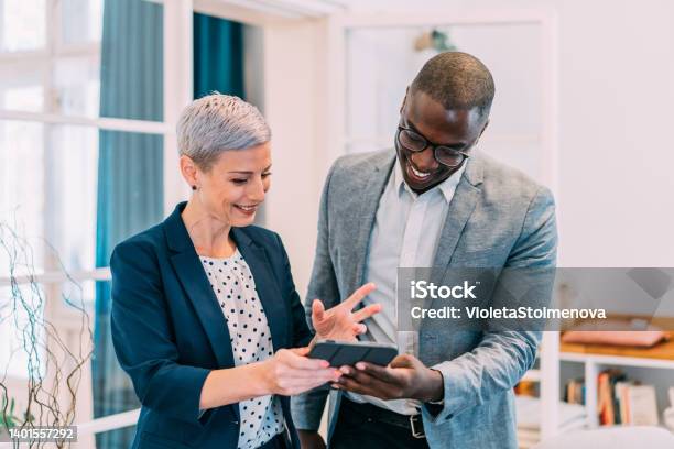 Confident Business Partners Working On Digital Tablet In Office Stock Photo - Download Image Now