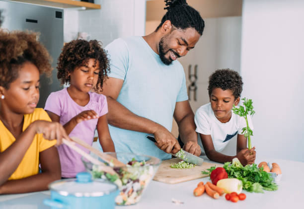 istock Happy family cooking together. 1401557331