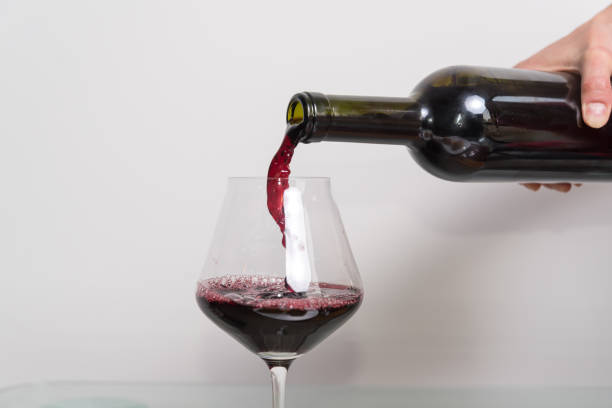 istock red wine entering into a crystal glass, selective focus 1401557548