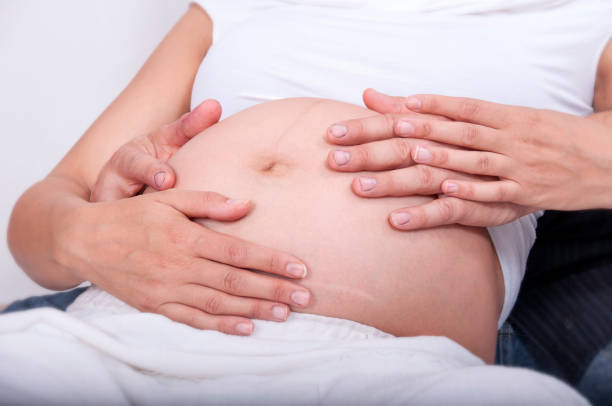 istock Mom and dad's hands on the belly 1401561261