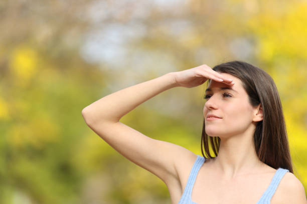 istock Teen contemplating protecting from sun in a park 1401562821