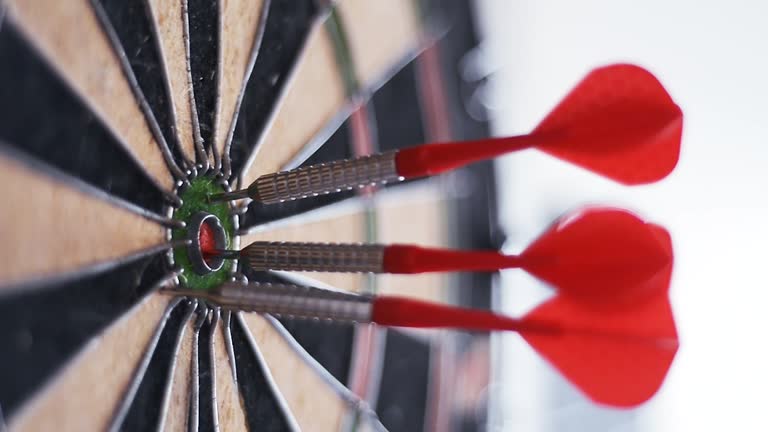 Darts hitting the bull's eye. High accuracy concept.