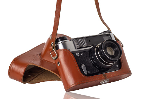 Camera in a vintage case isolated on a white background.