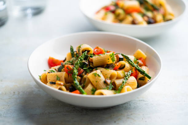 istock Pasta salad with grilled vegetables, zucchini, eggplant, asparagus and tomatoes. 1401565699