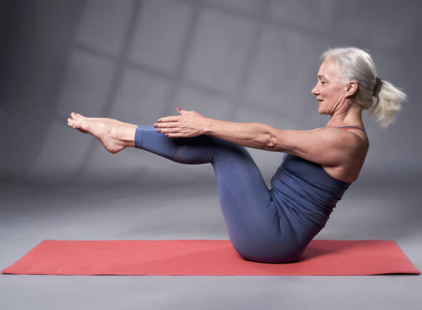 Senior woman in yoga pose stock photo