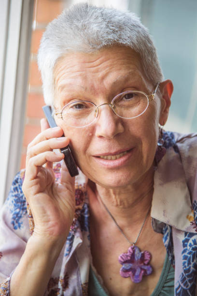 istock Senior woman having a friendly talk on her cell phone 1401568497