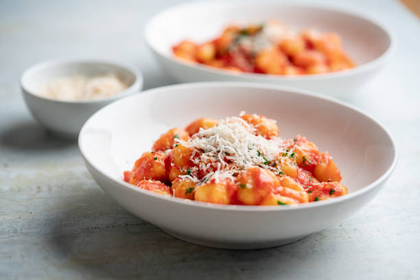 Gnocchi with tomato sauce and parmigiano on a plate. stock photo